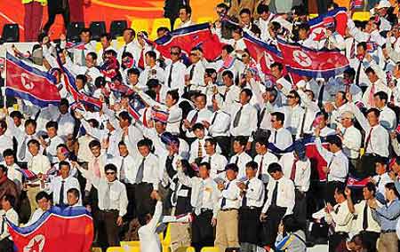 DPRK&apos;s cheering squad wave national flags during their 2011 Asian Cup Group D soccer match against United Arab Emirates at Qatar Sports Club stadium in Doha, Jan 11, 2011. [msn.com.cn] 