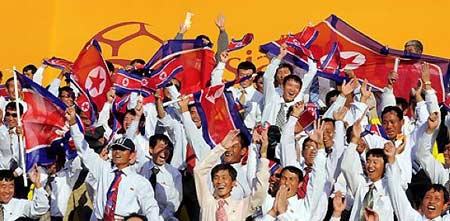 DPRK&apos;s cheering squad wave national flags during their 2011 Asian Cup Group D soccer match against United Arab Emirates at Qatar Sports Club stadium in Doha, Jan 11, 2011. [msn.com.cn] 