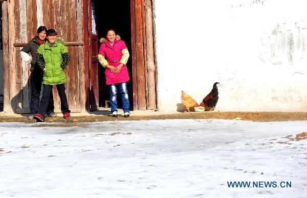 Villagers go outdoors to enjoy the sun in Ziyuan County, south China&apos;s Guangxi Province, Jan. 12, 2011. After a ten-day icy-rain disaster, the weather improved a lot in Ziyuan County on Wednesday. The sun came out, leading to a temperature rise and the melting of ice and snow. 