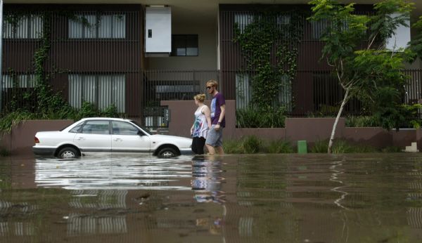 A couple walks past a flooded apartment building in the Brisbane suburb of West End A couple walks past a flooded apartment building in the Brisbane suburb of West End January 12, 2011. (Xinhua/Reuters)
