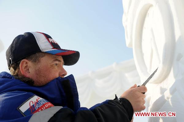 Photo taken on Jan. 6, 2011 shows a man from the Russian team, the championship winner, making final adjustment to his work at the 16th Snow Sculpture Contest held in Harbin, capital of northeast China&apos;s Heilongjiang Province. The 16th Snow Sculpture Contest wrapped up in Harbin on Thursday, with a Russian team, a Thai team and a Chinese team winning the champion and runner-ups respectively. [Xinhua]