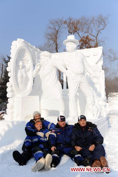 Photo taken on Jan. 6, 2011 shows a team from Russia, the championship winner, sitting with their work at the 16th Snow Sculpture Contest held in Harbin, capital of northeast China&apos;s Heilongjiang Province. The 16th Snow Sculpture Contest wrapped up in Harbin on Thursday, with a Russian team, a Thai team and a Chinese team winning the champion and runner-ups respectively. [Xinhua]