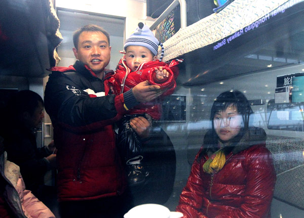 A family sits in a soft sleeper carriage that has been turned into seating for the D356 Shanghai-Chengdu train, Jan 13, 2011. [Xinhua]