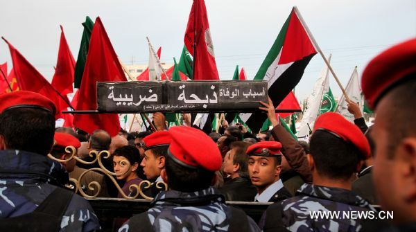 Protestors from opposition parties and labor unions shout anti-government slogans outside Jordanian Lower House during an anti-government demonstration in Amman, Jordan, on Jan. 16, 2011. Hundreds of Jordanians on Sunday staged a sit-in, calling for the resignation of the government and protesting rising prices in the country. [Xinhua]