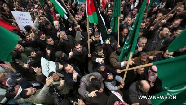 Protestors from opposition parties and labor unions shout anti-government slogans outside Jordanian Lower House during an anti-government demonstration in Amman, Jordan, on Jan. 16, 2011. Hundreds of Jordanians on Sunday staged a sit-in, calling for the resignation of the government and protesting rising prices in the country. [Xinhua]