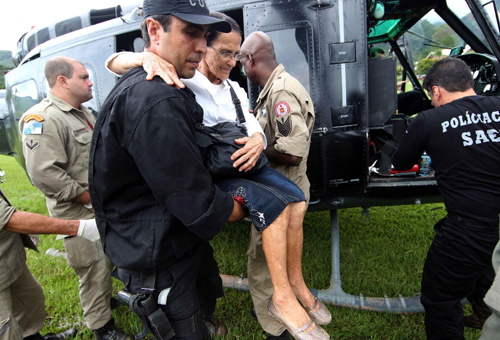 A landslide survivor is transferred to an air base after she is rescued by Brazilian policemen in the state of Rio de Janeiro, Brazil, Jan 16, 2011. [Xinhua]