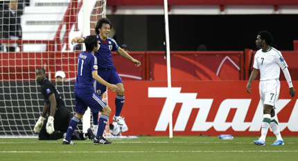 Japan's player Shinji Okazaki jumps up to celebrate with teammate Ryoichi Maeda after scoring a goal against Saudi Arabia during their AFC Asian Cup group B soccer match. On the right is Saudi Arabia's player Kamil Al Mousa and left is Saudi Arabia's goalkeeper Waleed Abdullah.
