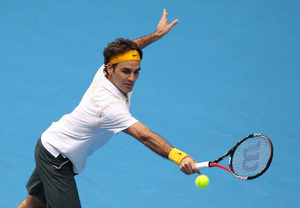 Roger Federer of Switzerland hits a shot to Lukas Lacko of Slovakia during their first round men's single match at the Australian Open tennis tournament in Melbourne, Australia, Jan 17, 2011. Federer won 3-0. (Xinhua/Meng Yongmin)