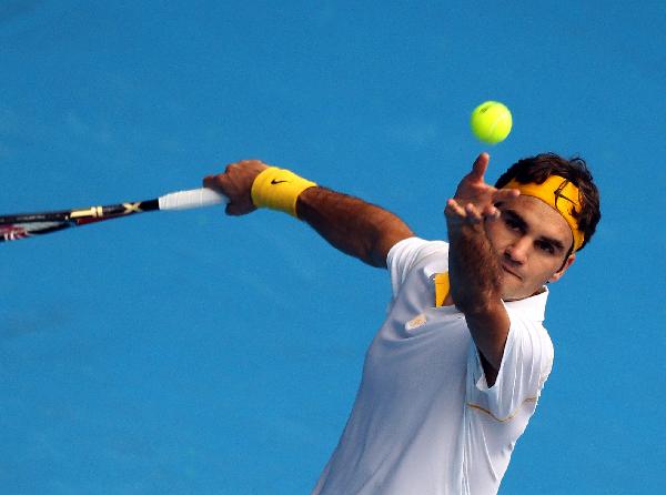 Roger Federer of Switzerland serves to Lukas Lacko of Slovakia during their first round men's single match at the Australian Open tennis tournament in Melbourne, Australia, Jan 17, 2011. Federer won 3-0. (Xinhua/Meng Yongmin)