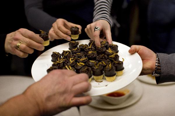 People try an insect snack (meal worm pralines) during a break in the lecture given by Professor Arnold van Huis at the University of Wageningen January 12, 2011. [Xinhua/Reuters] 