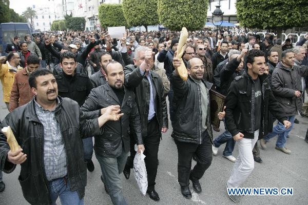 Protestors participate in a demonstration in downtown Tunis Jan. 18, 2010. Thousands of Tunisians flood the streets in downtown Tunis protesting against the interim government only one day after it was established, Xinhua reporter said. [Nasser Nouri/Xinhua]