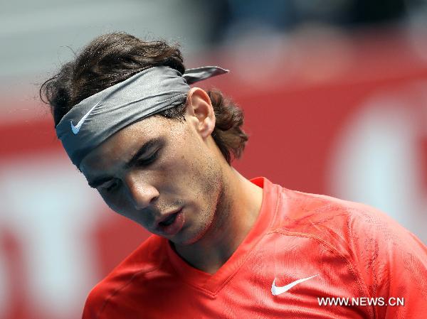 Spain's Rafael Nadal reacts during the men's singles first round match against Brazil's Marcos Daniel at the 2011 Australian Open tennis tournament in Melbourne, Australia, Jan. 18, 2011. (Xinhua/Meng Yongmin) 