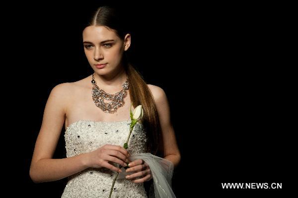 A model presents a creation designed by Italian fashion designer Mossi Giancarlo at Hong Kong Fashion Week for Fall/Winter 2011 in south China's Hong Kong, on Jan. 18, 2011.