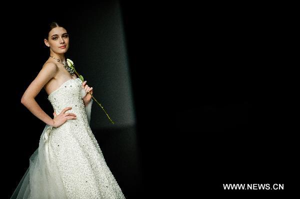 A model presents a creation designed by Italian fashion designer Mossi Giancarlo at Hong Kong Fashion Week for Fall/Winter 2011 in south China's Hong Kong, on Jan. 18, 2011.