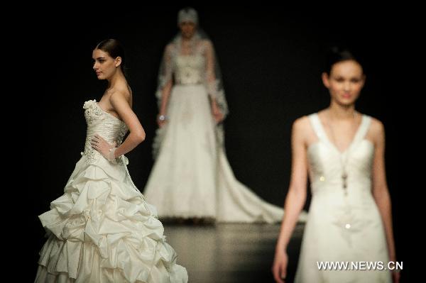 Models present creations designed by Italian fashion designer Mossi Giancarlo at Hong Kong Fashion Week for Fall/Winter 2011 in south China's Hong Kong, on Jan. 18, 2011.