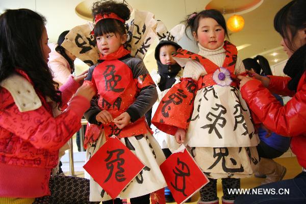 Children wear creations made of calligraphies written the Chinese character of rabbit, during a fashion show for kids at a kindergarten in Hanshan County, east China's Anhui Province, Jan. 17, 2011. The activity was held Monday to mark the upcoming Spring Festival of the year of rabbit, one of the twelve Chinese zodiac animals. 