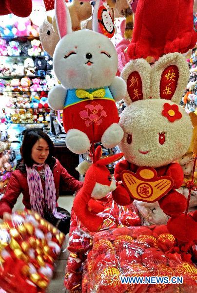 A vendor sets rabbit toys in her store in Yiwu Merchandise Market in east China's Zhejiang Province, Jan. 16, 2011. As the Chinese Spring Festival of the year of rabbit approaches, a variety of Spring Festival decorations including the plush rabbit toys and red Chinese lanterns were put on sale in the Yiwu Merchandise Market which attracted buyers both at home and abroad.