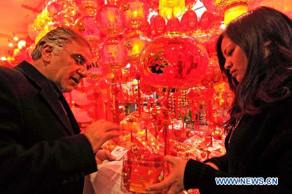 Iranian businessman Mahdi Namdari selects Chinese lanterns in Yiwu Merchandise Market in east China's Zhejiang Province, Jan. 16, 2011. As the Chinese Spring Festival of the year of rabbit approaches, a variety of Spring Festival decorations including the plush rabbit toys and red Chinese lanterns were put on sale in the Yiwu Merchandise Market which attracted buyers both at home and abroad. 