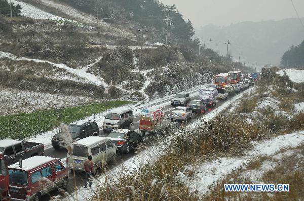 Vehicles are stuck on the frozen No. 308 Provincial Highway in Kaili, southwest China&apos;s Guizhou Province, Jan. 17, 2011. Snow and freezing rain hit the city of Kaili on Monday, trapping more than 2,000 vehicles in congestion. 