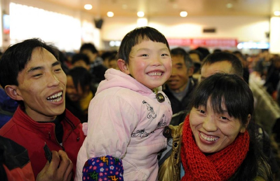 A child and her parents look happy waiting to go home at Hangzhou railway station in Hangzhou, capital city of East China&apos;s Zhejiang province, Jan 17, 2011. [Photo/Xinhua]