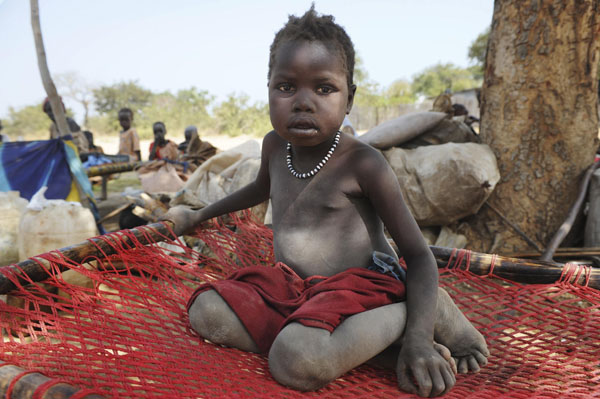 A newly arrived southern Sudanese child returnee from Darfur is photographed shortly after being dropped off from a bus in Wanjok, near Aweil in Northern Bhar El-Ghazal January 16, 2011. [Xinhua/Reuters]