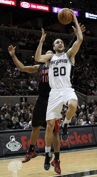 San Antonio Spurs Manu Ginobili (R) goes to the basket against Toronto Raptors DeMar DeRozan during the first half of their NBA basketball game in San Antonio, Texas, January 19, 2011. (Xinhua/Reuters Photo)