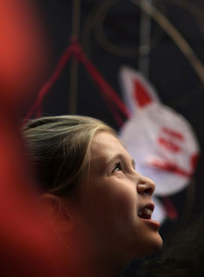 A French girl looks at a rabbit-shaped lantern during an event promoting the upcoming Chinese New Year at the China Culture Center in Paris, capital of France, Jan 22, 2011. [Xinhua]
