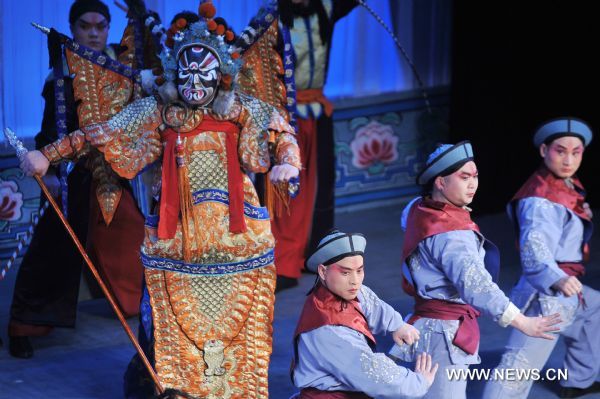 Actors perform Peking Opera in Shenyang, capital of northeast China's Liaoning Province, Jan. 23, 2011. Local Peking Opera troupe performed on Sunday for citizens free of charge, to celebrate the upcoming Chinese Lunar New Year. 