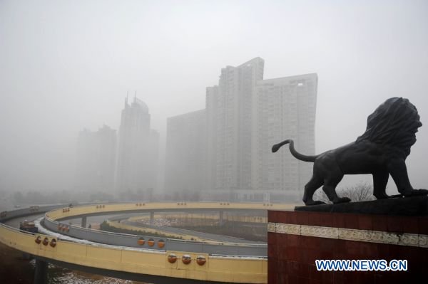 Buildings are enveloped in fog in Nanchang, east China&apos;s Jiangxi province on Jan. 23, 2011. Nanchang was enveloped in fog on Sunday and the visibility in part of the city reduced to 50 meters.