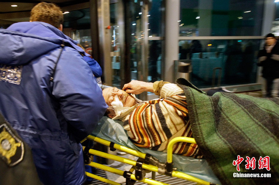 Medics wheel a victim of a bomb explosion at Moscow&apos;s Domodedovo airport January 24, 2011. 