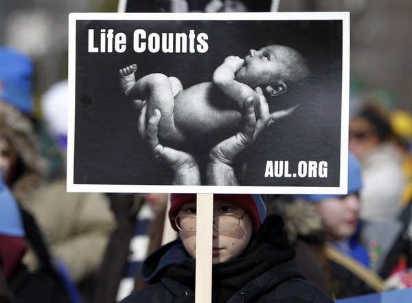 A young pro-life protester is pictured on the Washington Mall during the annual March for Life, Jan 24, 2011. On the 38th anniversary of the landmark Roe v. Wade abortion-rights decision, thousands marched to the US Supreme Court to voice their opposition to abortion rights. [China Daily/Agencies]