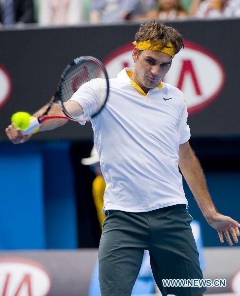 Roger Federer of Switzerland hits a return to his compatriot Stanislas Wawrinka during the quarterfinal match of men's singles at the Australian Open tennis tournament in Melbourne, Australia, Jan. 25, 2011. Federer won 3-0 to enter the semifinals. (Xinhua/Chen Duo)