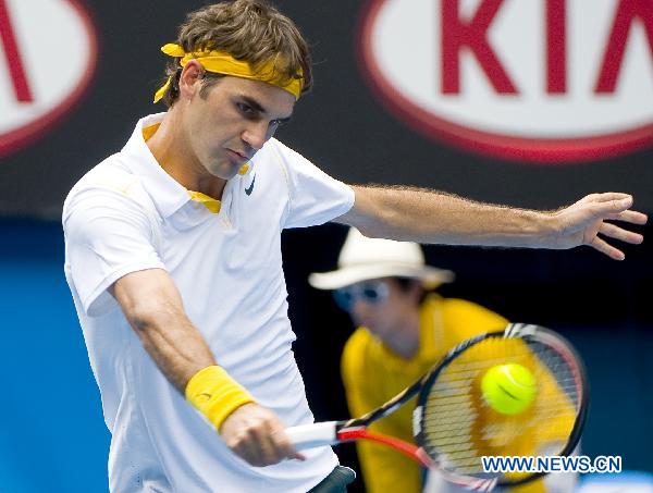 Roger Federer of Switzerland hits a return to his compatriot Stanislas Wawrinka during the quarterfinal match of men's singles at the Australian Open tennis tournament in Melbourne, Australia, Jan. 25, 2011. Federer won 3-0 to enter the semifinals. (Xinhua/Chen Duo)