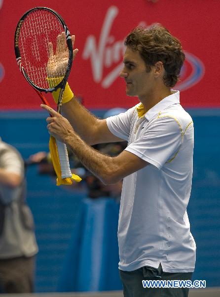 Roger Federer of Switzerland celebrates winning against his compatriot Stanislas Wawrinka during the quarterfinal match of men's singles at the Australian Open tennis tournament in Melbourne, Australia, Jan. 25, 2011. Federer won 3-0 to enter the semifinals. (Xinhua/Chen Duo)