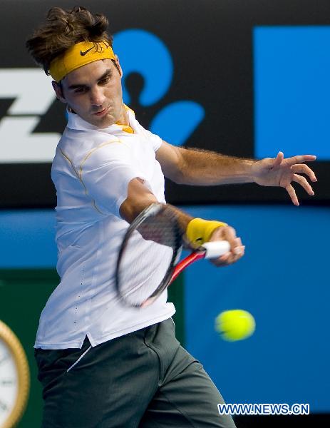 Roger Federer of Switzerland hits a return to his compatriot Stanislas Wawrinka during the quarterfinal match of men's singles at the Australian Open tennis tournament in Melbourne, Australia, Jan. 25, 2011. Federer won 3-0 to enter the semifinals. (Xinhua/Chen Duo)