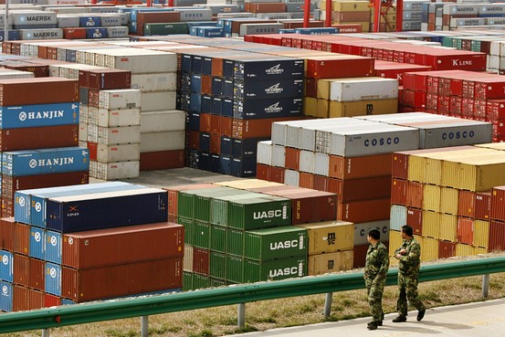 Workers walk amongst shipping containers at a port in China. The Ministry of Commerce said there is no immediate plan to launch more tax rebate policies, commenting on a report that several ministries are mulling cutting export rebates on certain products.