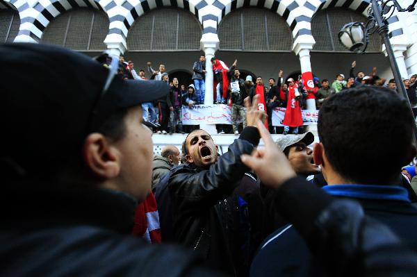 Protesters from Tunisia&apos;s marginalised rural heartlands chant slogans as they prepare to spend their second night outside the Prime Minister&apos;s office in Tunis January 24, 2011. Protesters demonstrated in the capital on Sunday to demand that the revolution they started should now sweep the remnants of the fallen president&apos;s old guard from power. [Xinhua]