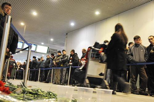 Mourners place flowers on Tuesday in Moscow&apos;s Domodedovo airport where 35 people were killed in a suicide bombing on Jan 24, 2011. [Photo/Xinhua]