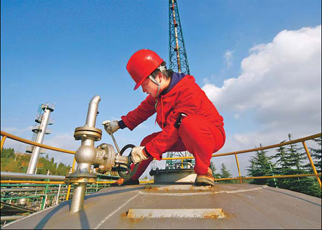 A worker at a natural gas plant in Suining, Sichuan province. The Ministry of Finance said the country will apply the resource tax, currently on oil and natural gas, to coal and water. [China Daily]