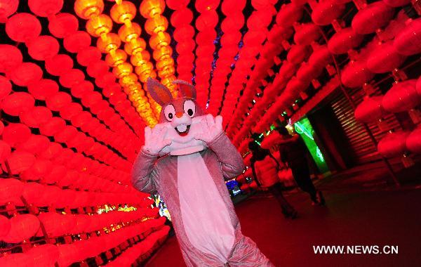 A rabbit impersonated by a park staff member gestures during the 17th Zigong International Dinosaur Lantern Festival in Zigong, southwest China's Sichuan Province, Jan. 24, 2011. The lantern festival, which kicked off on Monday, will last for 43 days to celebrate the Chinese Spring Festival which falls on Feb. 3 this year. 