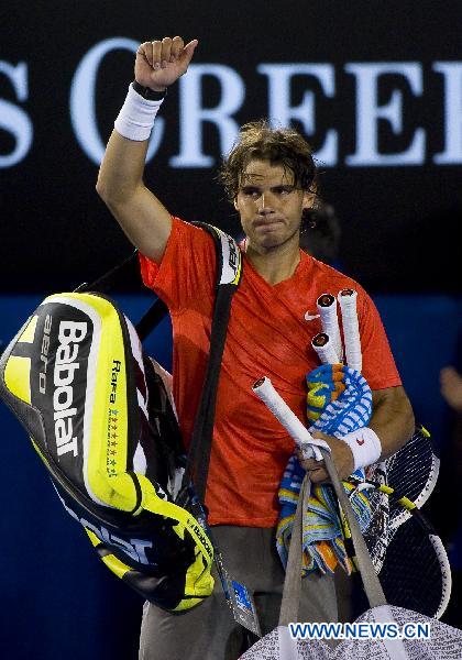 Rafael Nadal of Spain waves to the audience after losing the men's singles quarterfinal against his compatriot David Ferrer at the Australian Open tennis tournament in Melbourne, Australia, on Jan. 26, 2011. Nadal failed to qualify for the semifinal after losing the match 0-3. (Xinhua/Chen Duo)