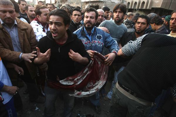 People gather at the bombing site in Baghdad's northwestern neighborhood of Shula. Up to 48 people were killed and 121 others were wounded in a car bomb explosion at a funeral tent in northwestern Baghdad on Thursday. [Xinhua]