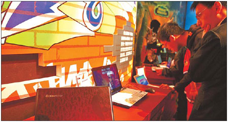 Lenovo laptops at an exhibition in Beijing. Lenovo said it will have a 51 percent stake in a new PC production venture with NEC. [China Daily]