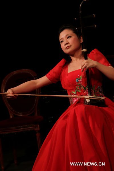 A Chinese musician plays Erhu, a traditional Chinese folk musical instrument in Paris, capital of France, Jan. 27, 2011. A concert celebrating upcoming Chinese lunar new year was performed by musicians from China's Shanghai Traditional Music Orchestra here on Thursday.