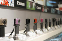 This photo taken on Thursday, January 27, 2011 shows digital cameras in an electronics and appliance store in Beijing. China on Thursday halved the import tax on electronic products, including computers and digital cameras.[Xinhua]