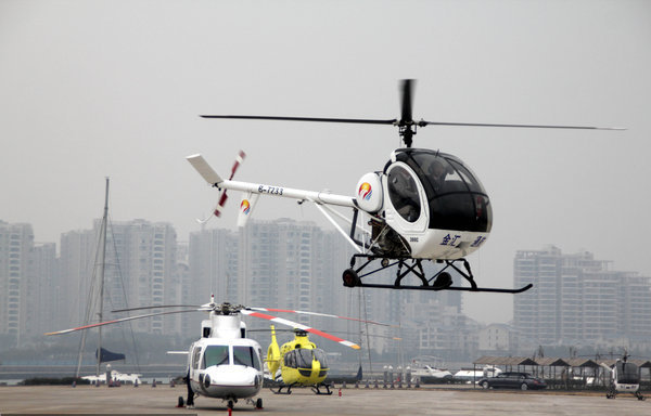 A helicopter takes off for a test-fly in Haikou, capital of South China&apos;s Hainan province, Jan 28, 2011. The low-altitude airspace management reform test-fly, the first of its kind in China, launched here on Friday. The nearly two-month test-fly marked the beginning of the low-altitude airspace management in Hainan.[CFP] 