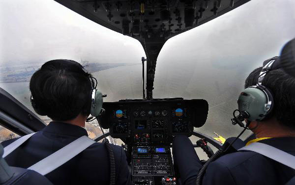 Two pilots are seen in a helicopter cockpit in Haikou, capital of South China&apos;s Hainan province, Jan 28, 2011. [Xinhua]