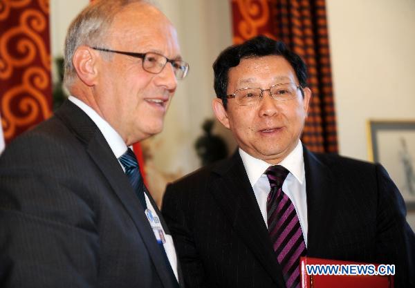 Chinese Minister of Commerce Chen Deming (R) and Swiss Economy Minister Johann Schneider-Ammann are seen during a signing ceremony to mark the official launch of negotiations between Switzerland and China for a comprehensive Free Trade Agreement, in Davos, Switzerland, on Jan. 28, 2011. 