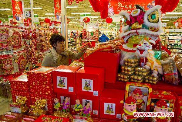 A customer shops for the upcoming Chinese Lunar New Year, or the Spring Festival, at a Chinese supermarket in Toronto, Canada, Jan. 28, 2011. (Xinhua