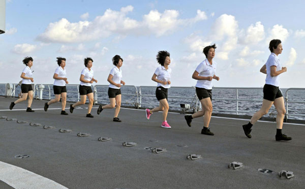 Photo taken on Jan 12, 2011 shows female soldiers doing physical exercises on the Chinese supplying ship &apos;Qiandaohu&apos;. [Photo/Xinhua]